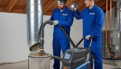 Technician cleaning air ducts for home HVAC system in Alexandria, VA